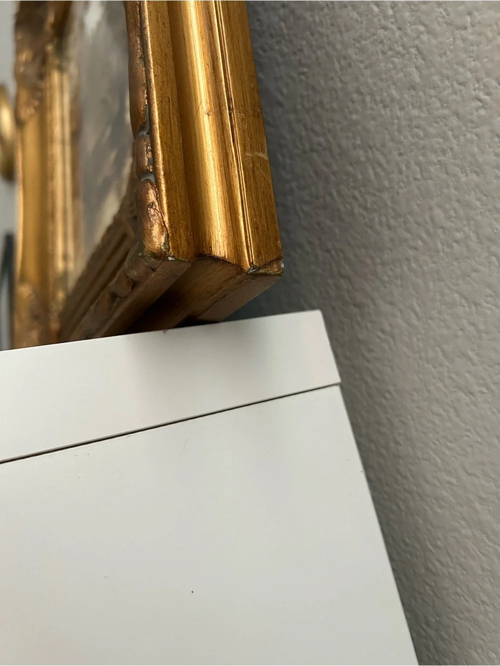 Framed art in gilded ornate frame